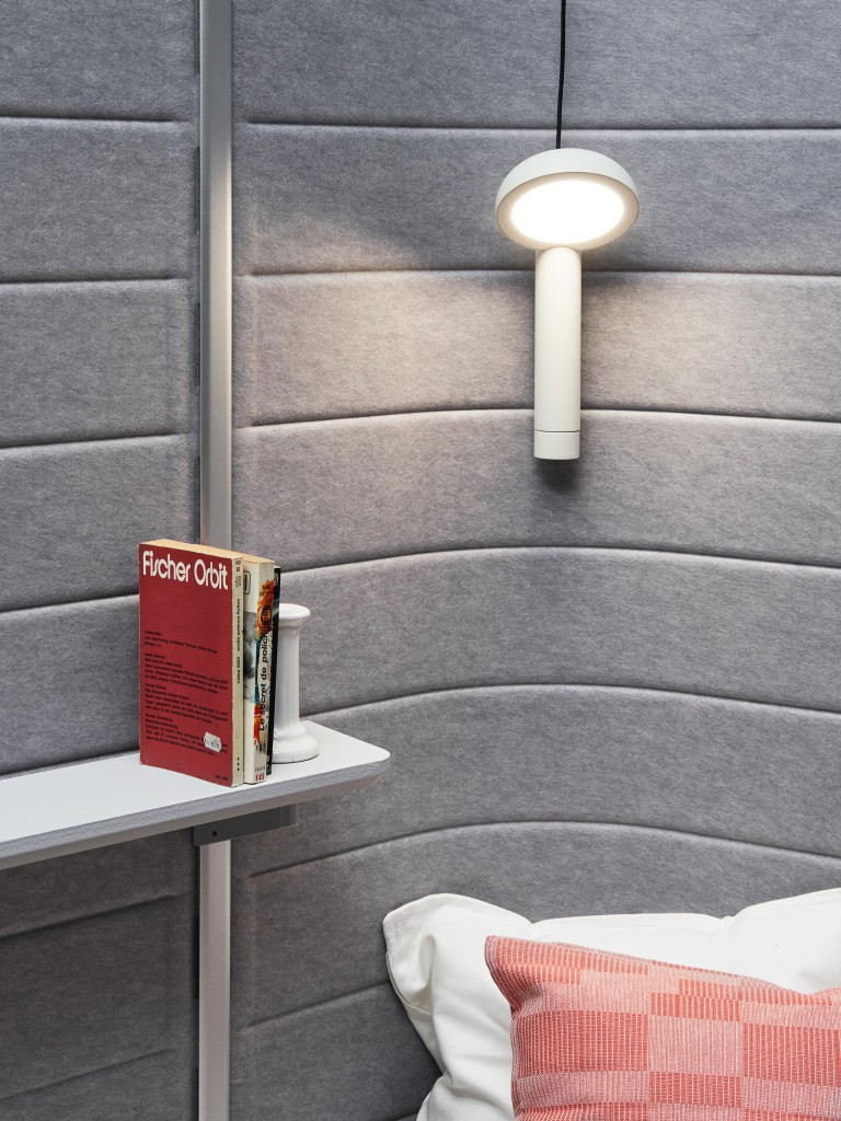 Magnetic Lamp by Yen-Hao Chu. Running along the grooves that punctuate the Workbays felt walls, this small lamp slides sideways to provide extra lighting where it is needed. 
